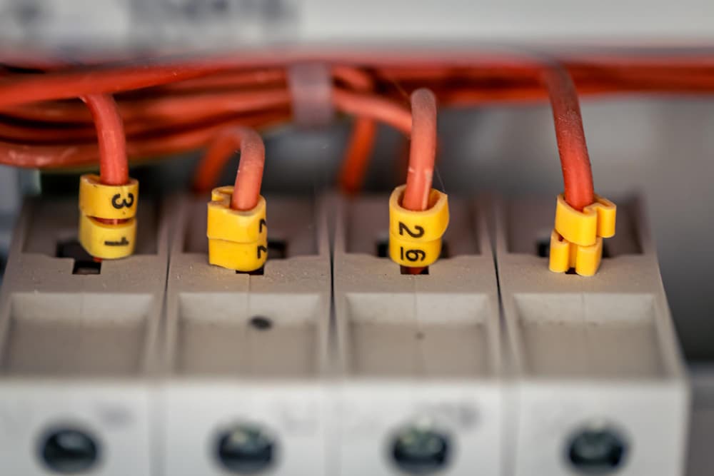 Technician working on wiring inside a service area